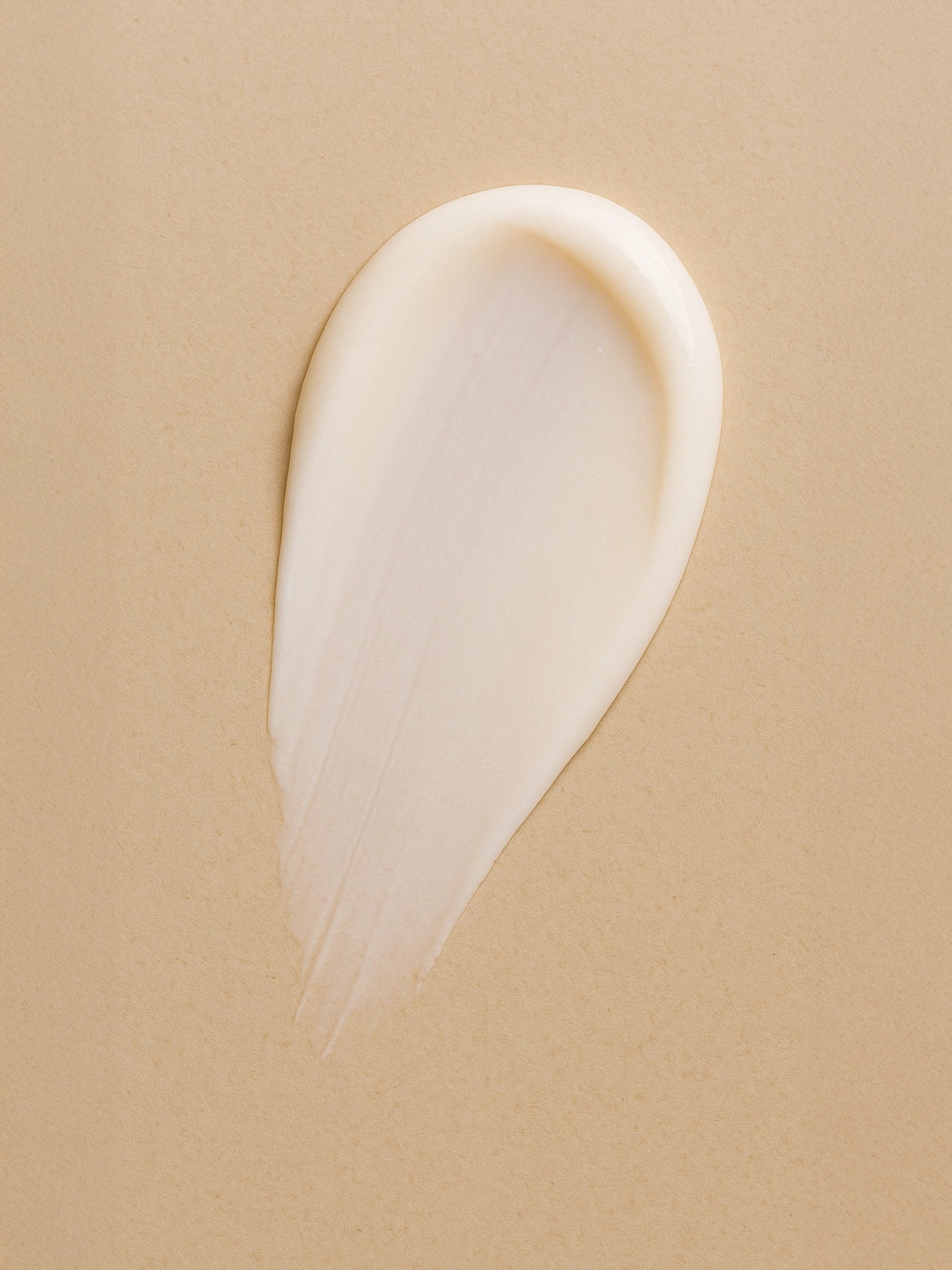 White cream smear on a beige background Light Moisturising Day Cream