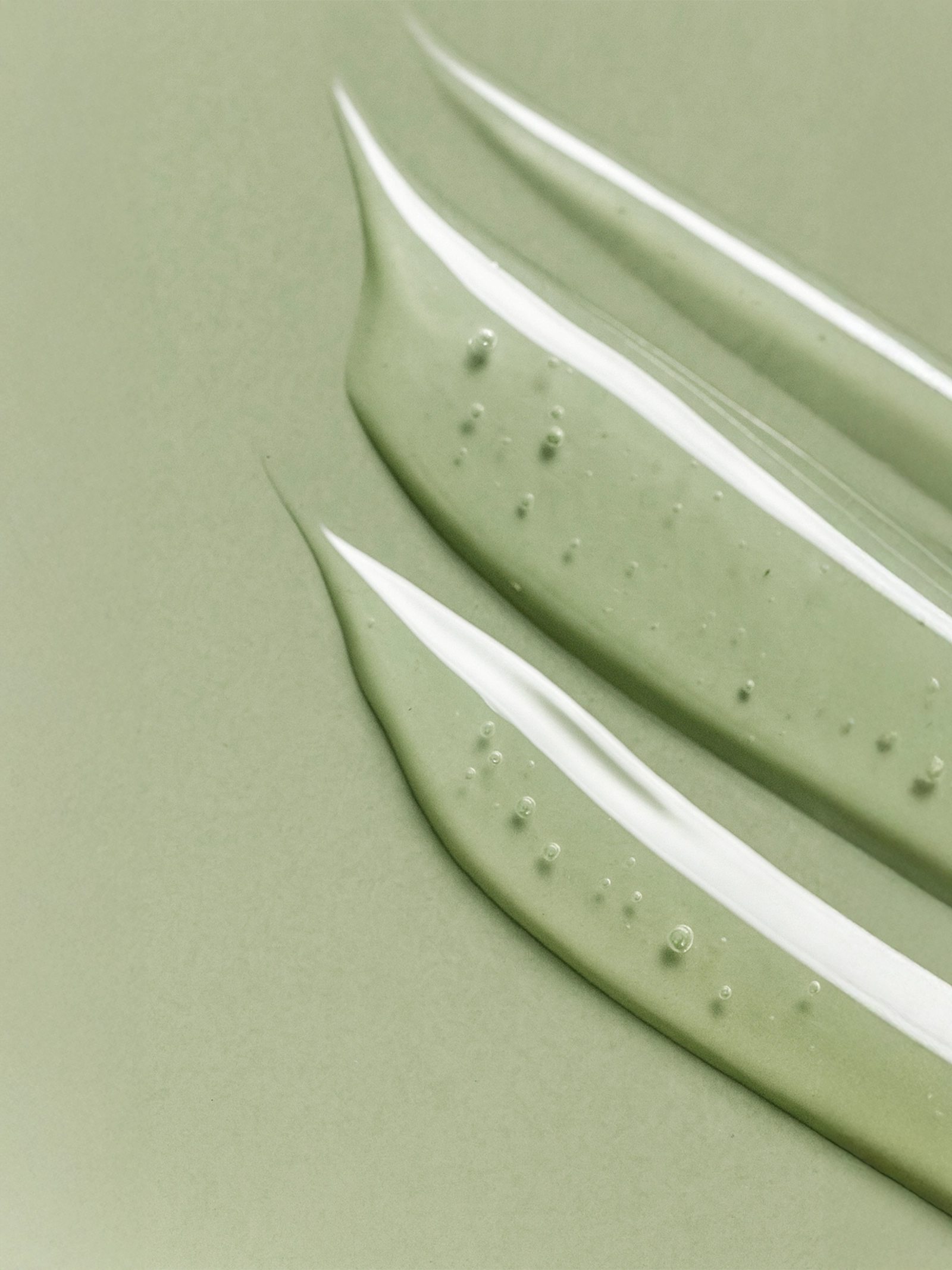 Close-up of green paint swatches on a light green background Niacinamide Gel Moisturiser