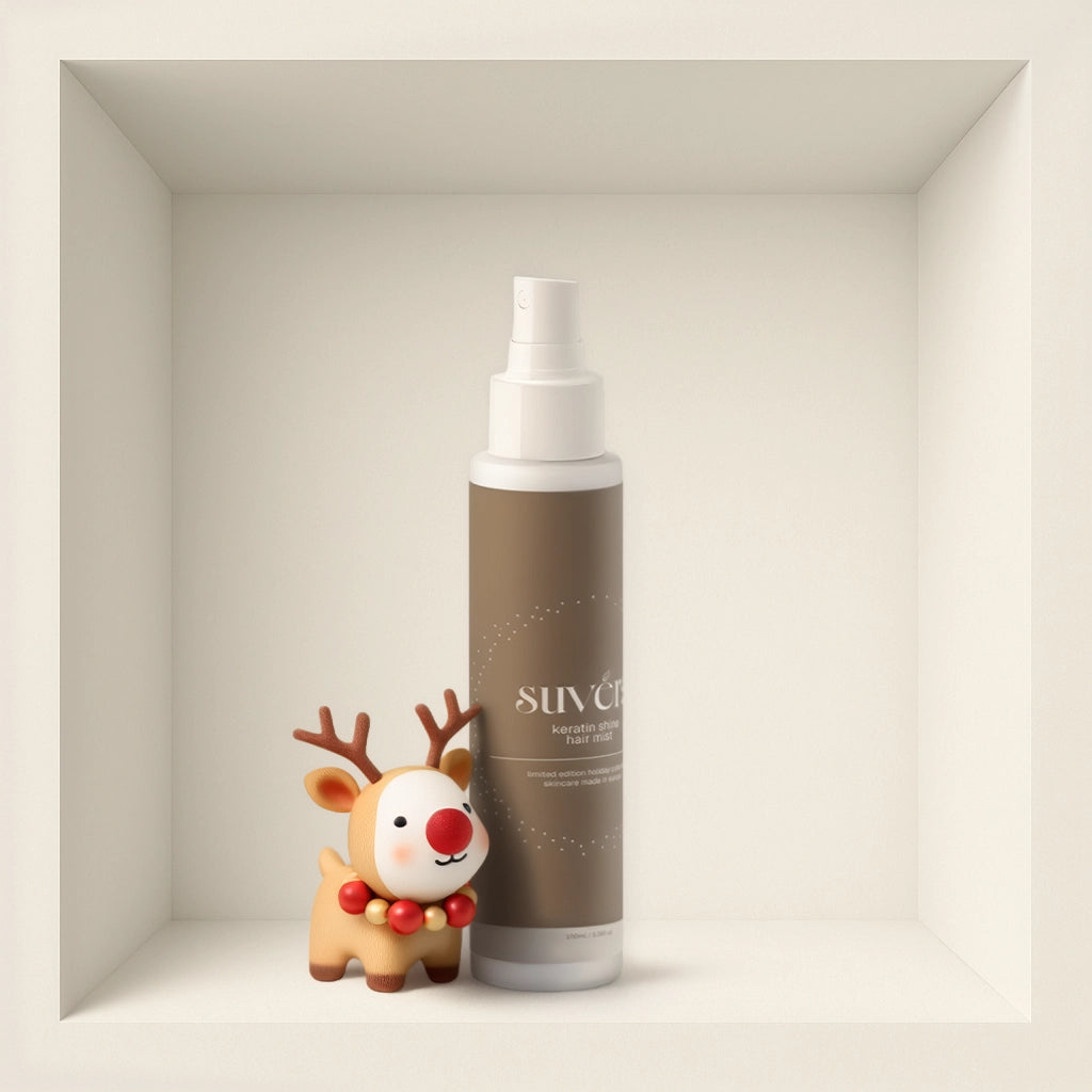 Bottle of 'Suvera' hair mist with a small reindeer figurine on a neutral background