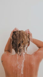 Luxurious vetiver shampoo texture by Suvéra, airy mint-green lather and botanical leaves, clean beauty self care skincare, eco conscious