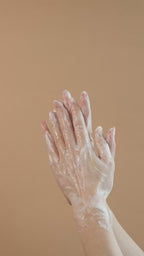 Suvéra self-care scene of minty botanicals and dark stones with realistic soap lather, evoking peppermint freshness and cedar warmth