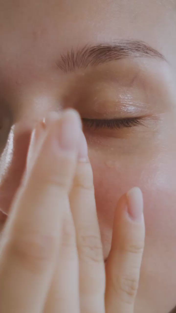 Female Skincare model wiping face with soothing natural vegan face care cream