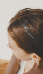 Close-up macro texture of Fresh Cocktail Conditioner showing creamy white formula with smooth and ribbed patterns, highlighting a rich hydrating consistency and glossy finish.