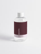 Suvera Glycolic Acid Liquid Exfoliator bottle with floral background